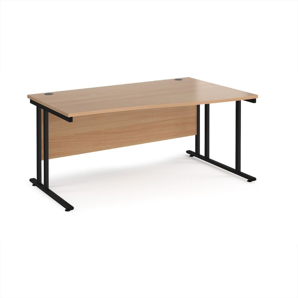 Large adjustable office desk with expandable width and depth, wood effect desktop, integrated modesty panel and black steel leg structure for flexible commercial environments