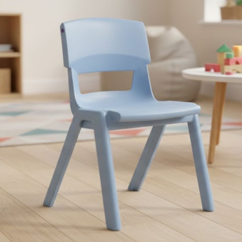 A pale blue nursery chair on light wood flooring, set in a soft, calm early years learning space with soft furnishings and toys.