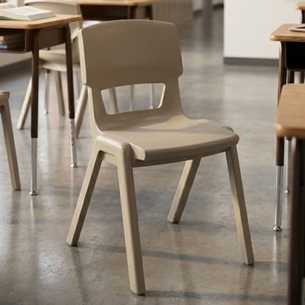 Durable beige plastic classroom chair with cut-out backrest, ideal for school environments
