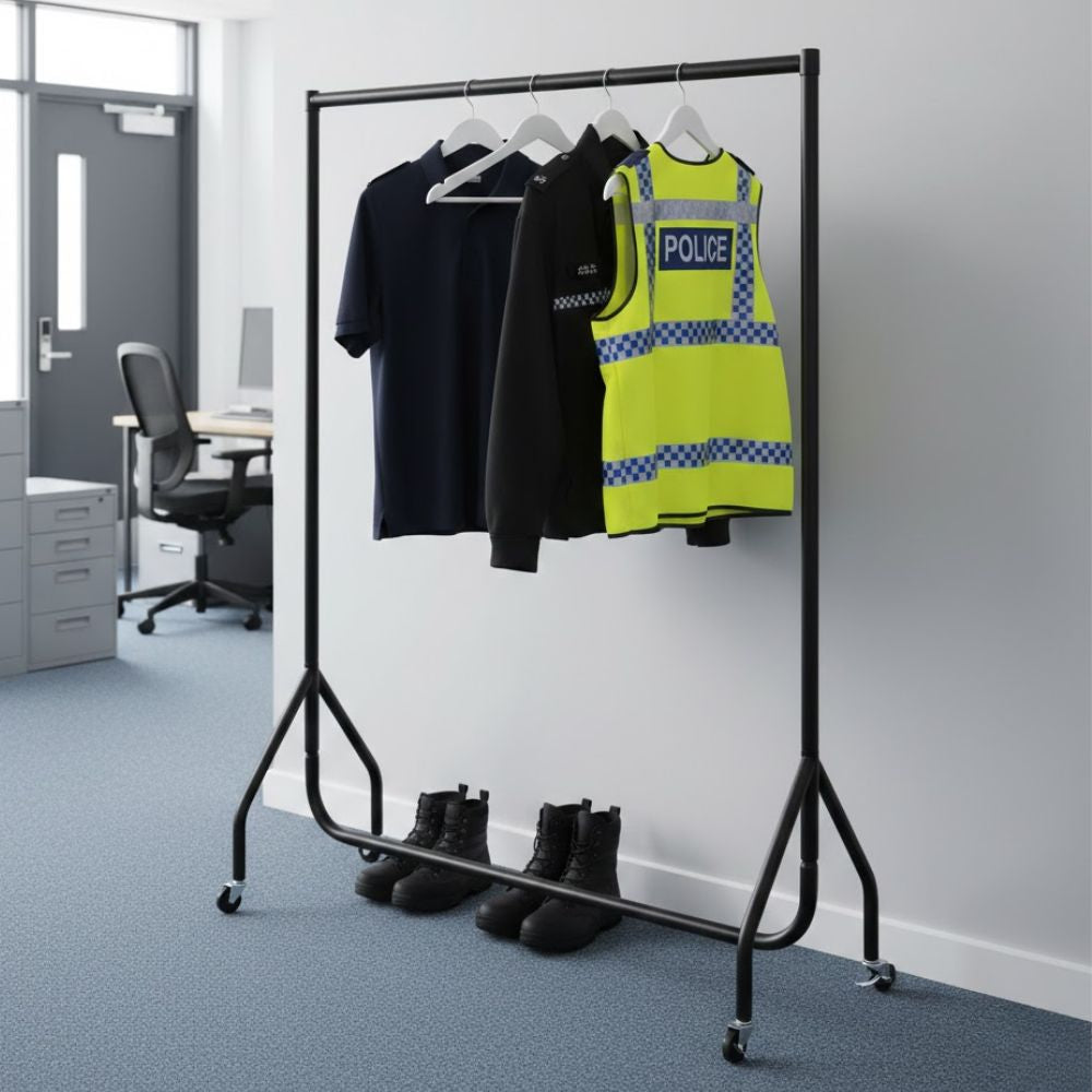 Black 4ft mobile clothes rail displaying police uniform items including a high-visibility vest and jackets on hangers in an office environment, with boots stored below.