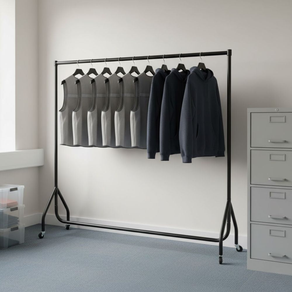 Black 6ft wheeled clothes rail displaying workwear vests and dark hooded tops on hangers in a tidy workplace setting.
