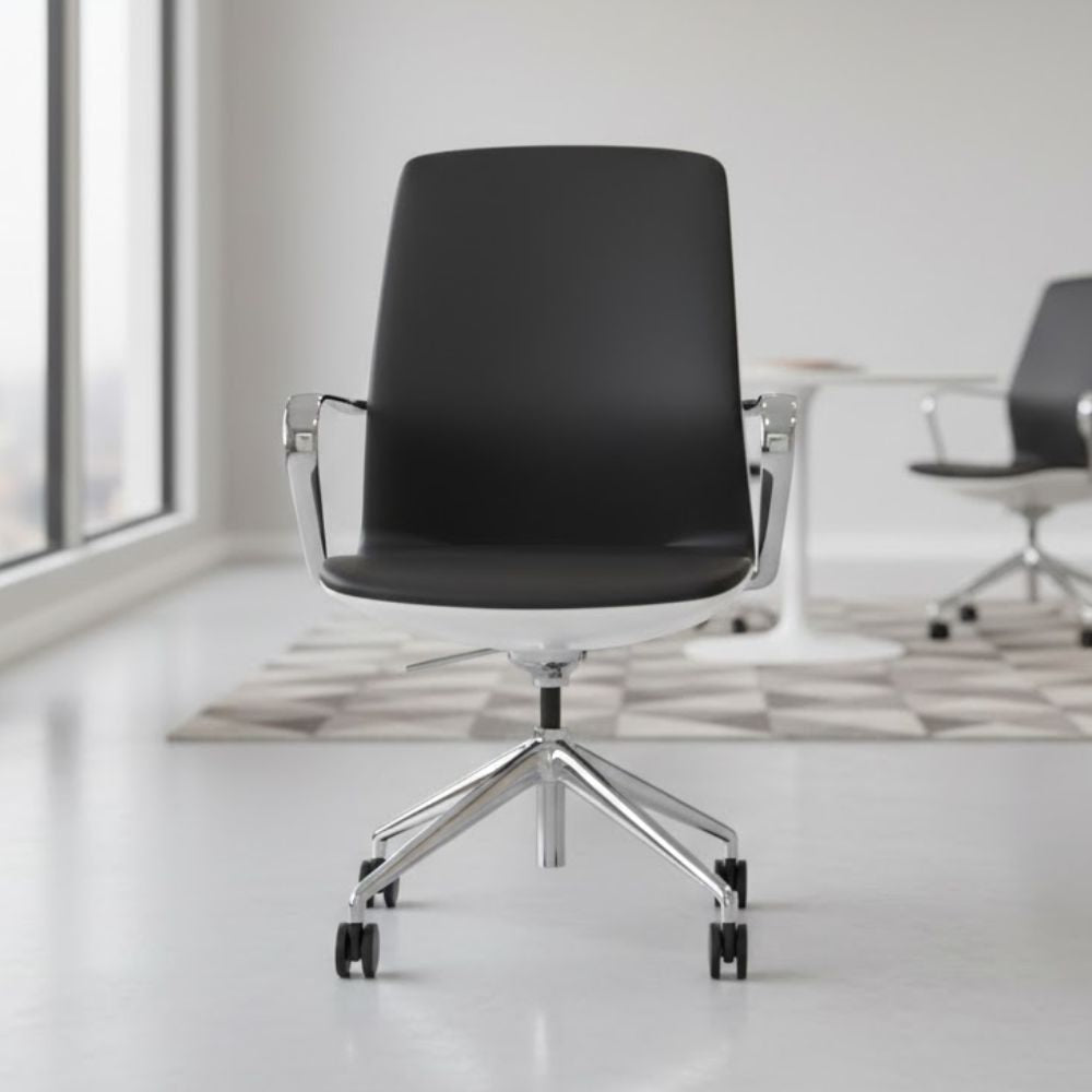 Contemporary black leather executive chair with sleek chrome legs and armrests, placed in a minimalist meeting room with large windows and geometric flooring.