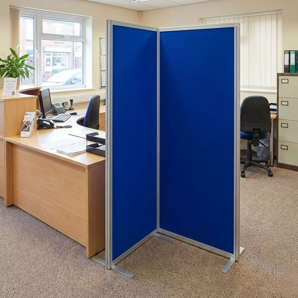 Blue and grey panel aluminium freestanding display board positioned in an office environment beside desks and filing cabinets, creating a temporary partition.