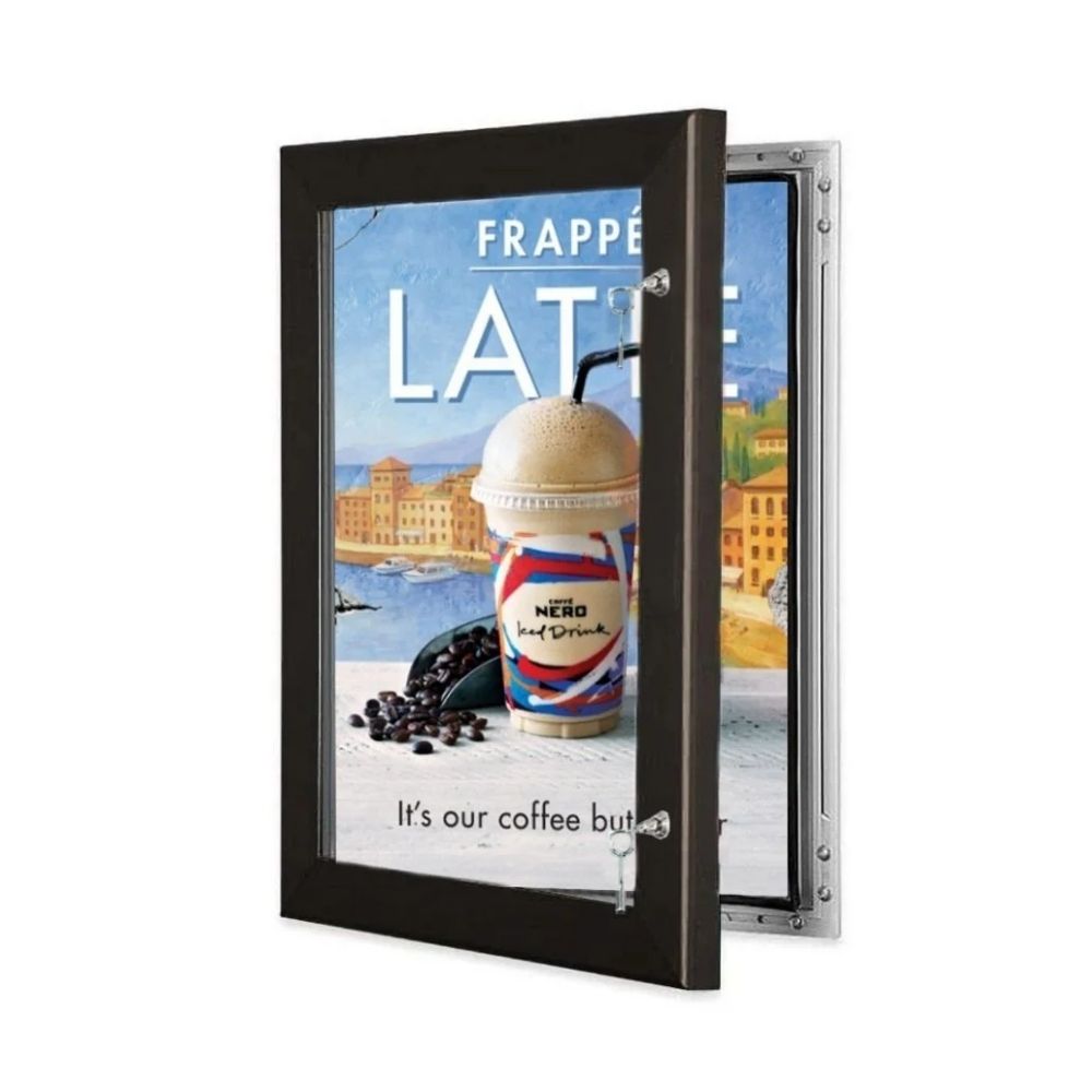Caffè Nero poster with scenic backdrop and frappé latte, shown inside an open wall-mounted frame.