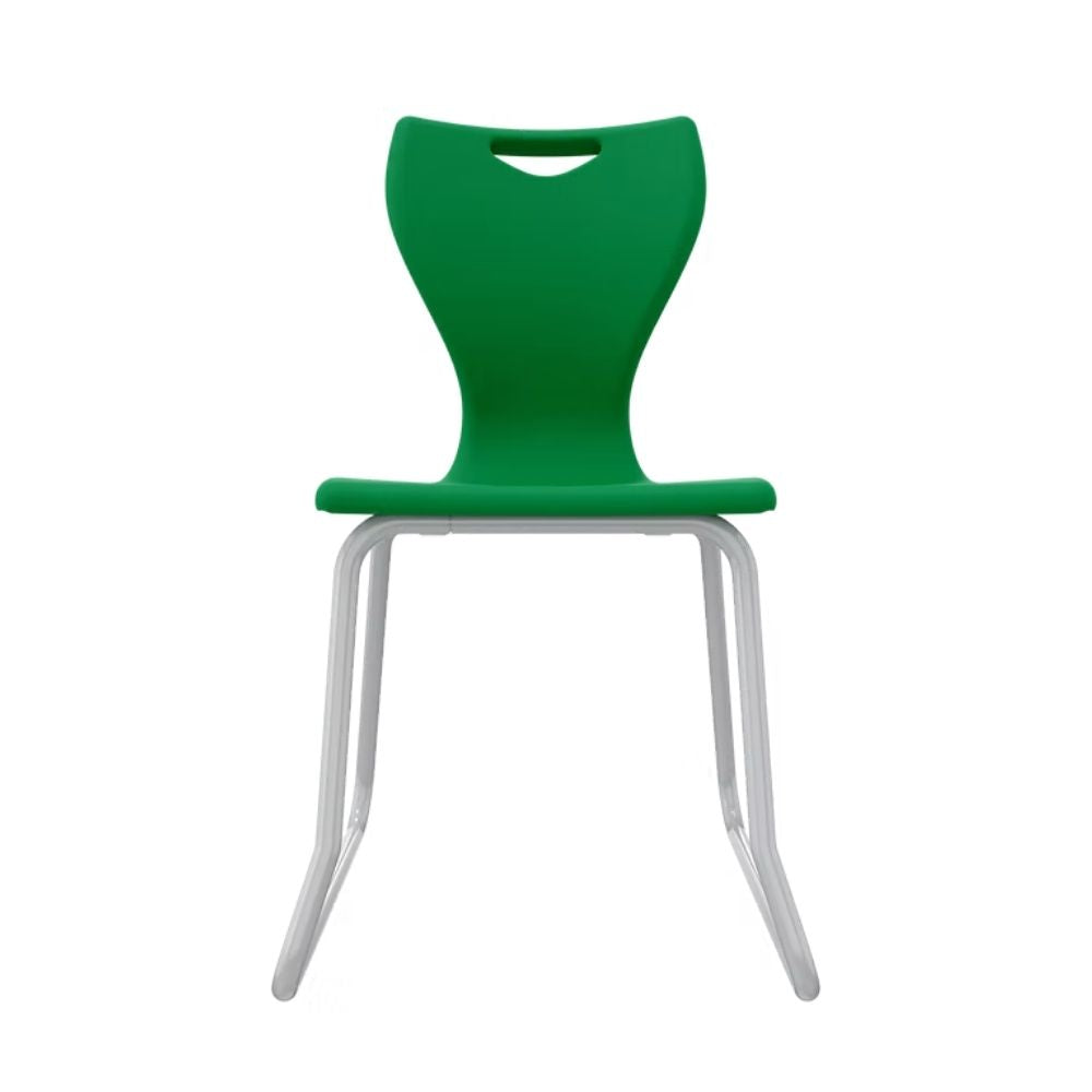 A robust dark green student chair for senior classrooms, featuring a full-radius steel sled base to prevent tipping and provide superior floor protection.