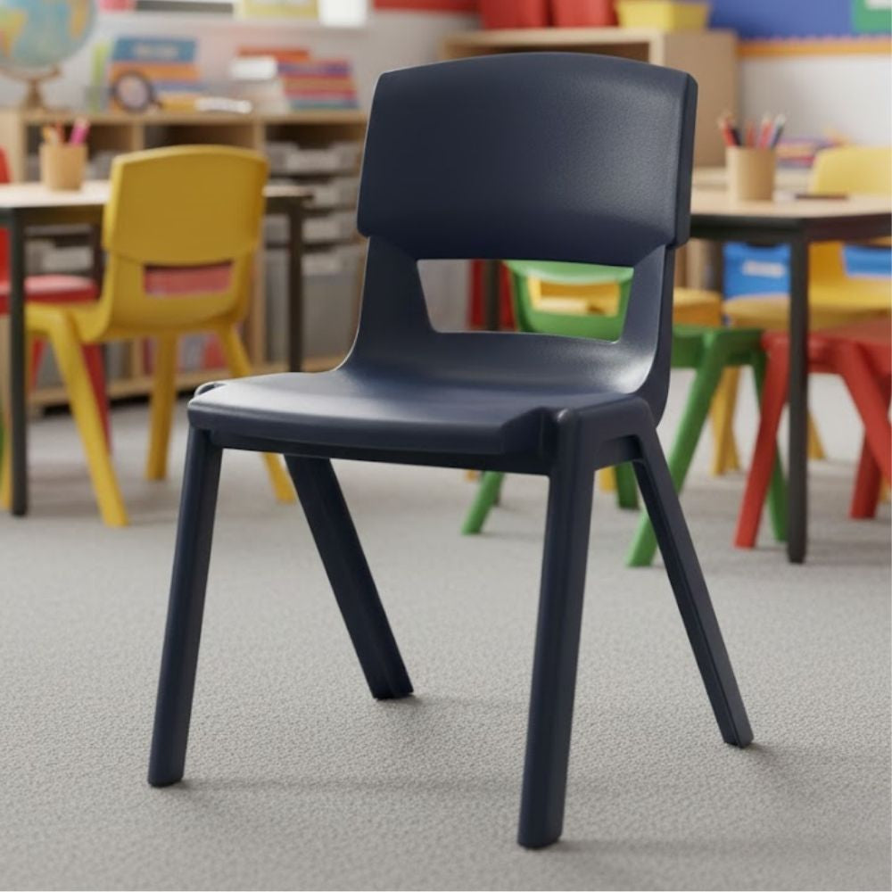 A dark grey ergonomic primary school chair in a colourful classroom with rainbow furniture, encouraging interactive and inclusive learning.