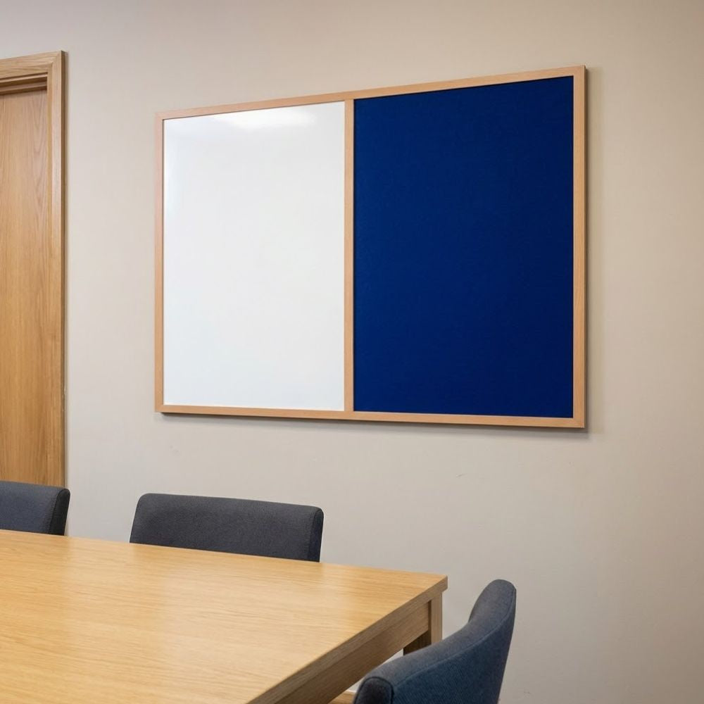 Eco-friendly 600 x 900mm combination board featuring a blue felt panel and whiteboard surface in a natural wood frame, installed on a meeting room wall above a conference table.