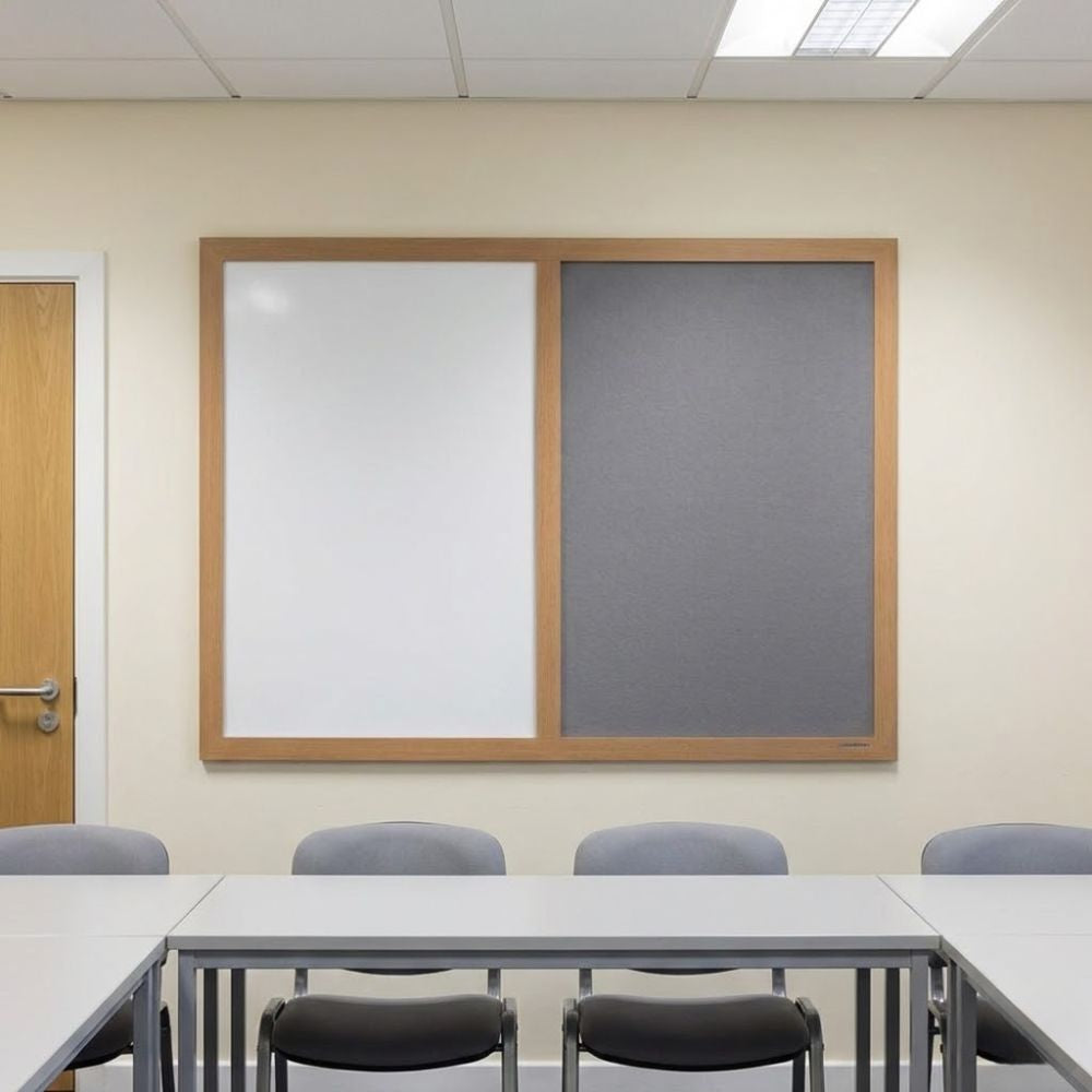 Eco-friendly 1500 x 1200mm combination board with grey felt panel and whiteboard surface in a light wood frame, displayed on a meeting room wall above tables and chairs.