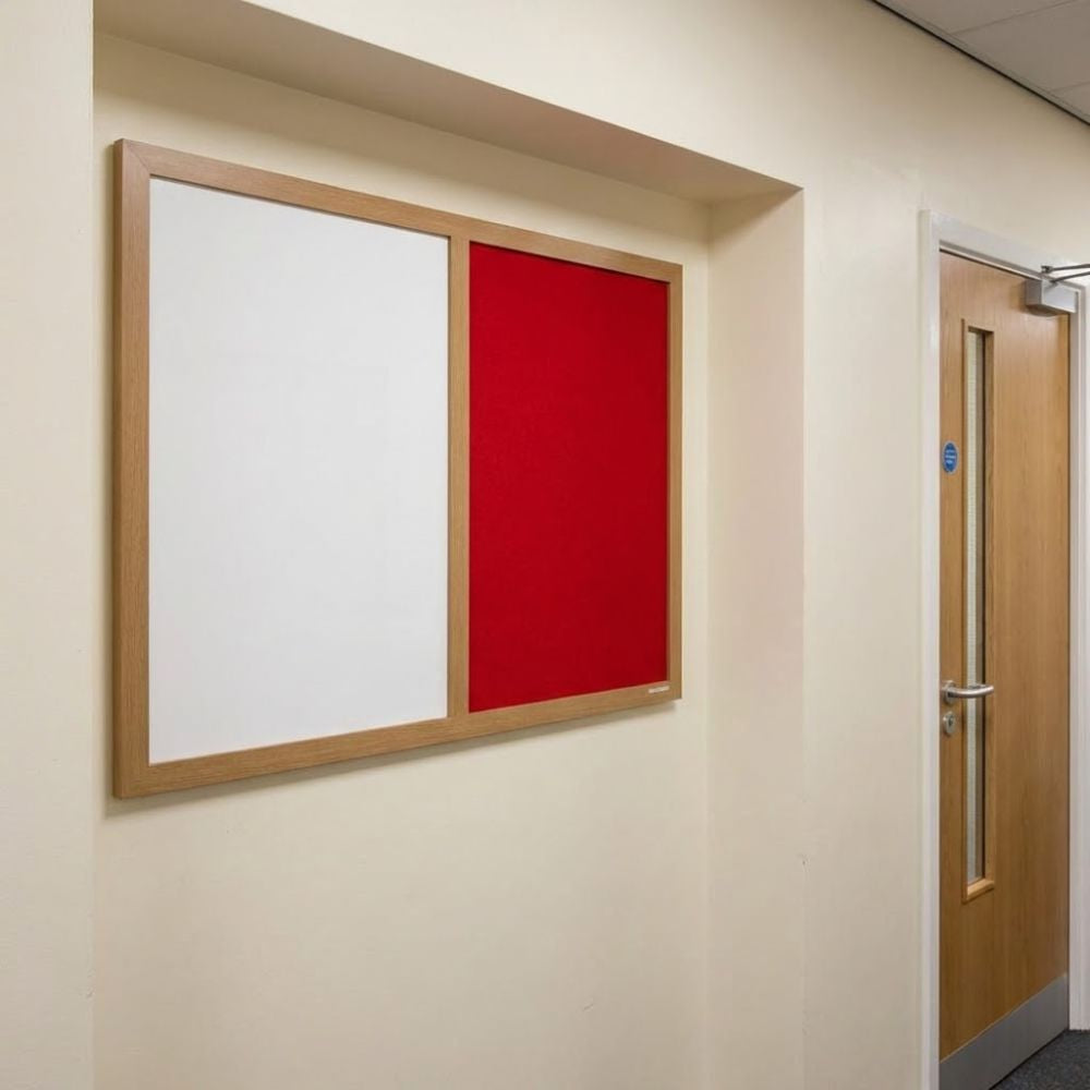 Eco-friendly 600 x 900mm combination board with red felt panel and whiteboard surface in a natural wood frame, mounted on a corridor wall beside a wooden door.