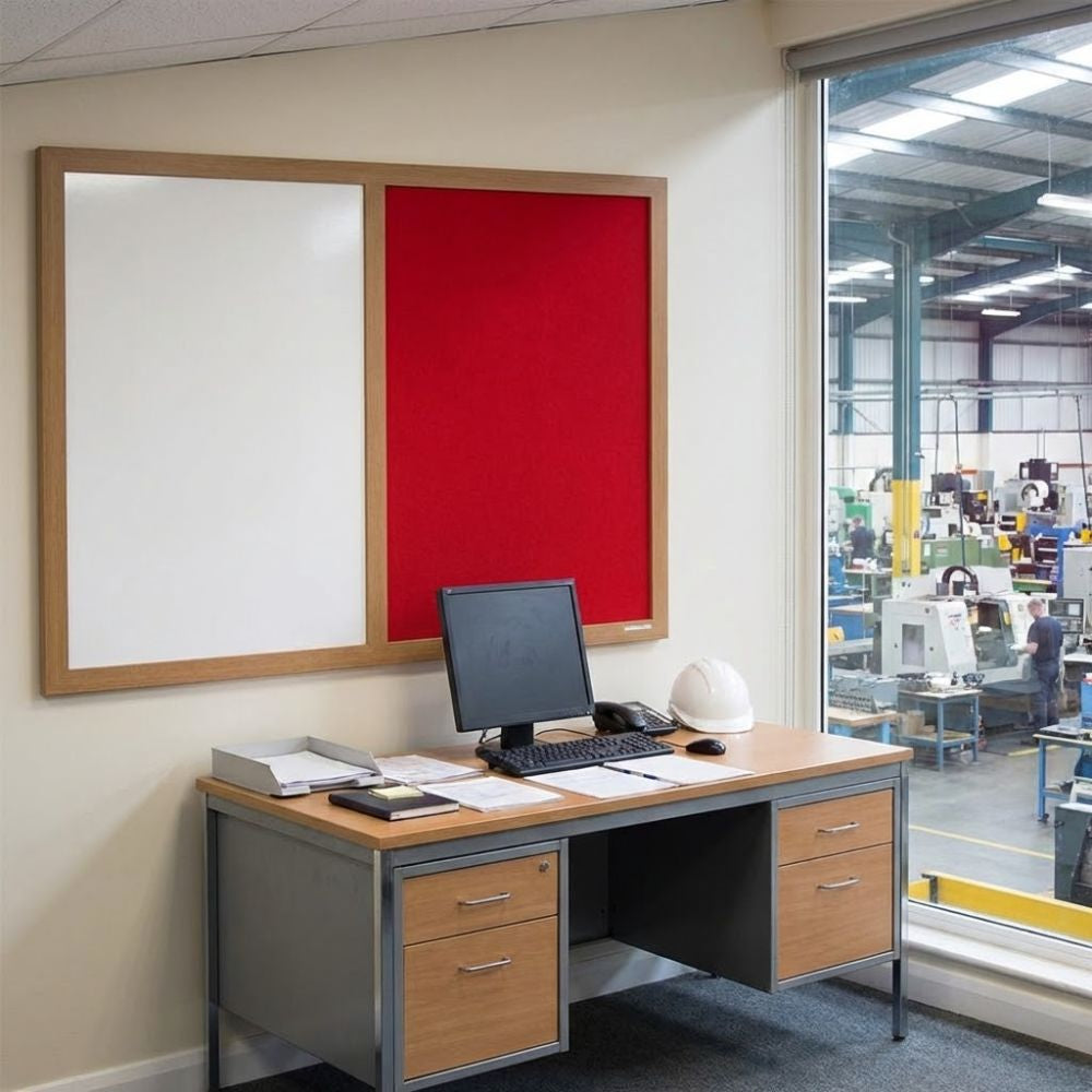 Eco-friendly combination board featuring a red felt panel and whiteboard surface in a natural wood frame, mounted on an office wall overlooking an industrial workspace through a large window.