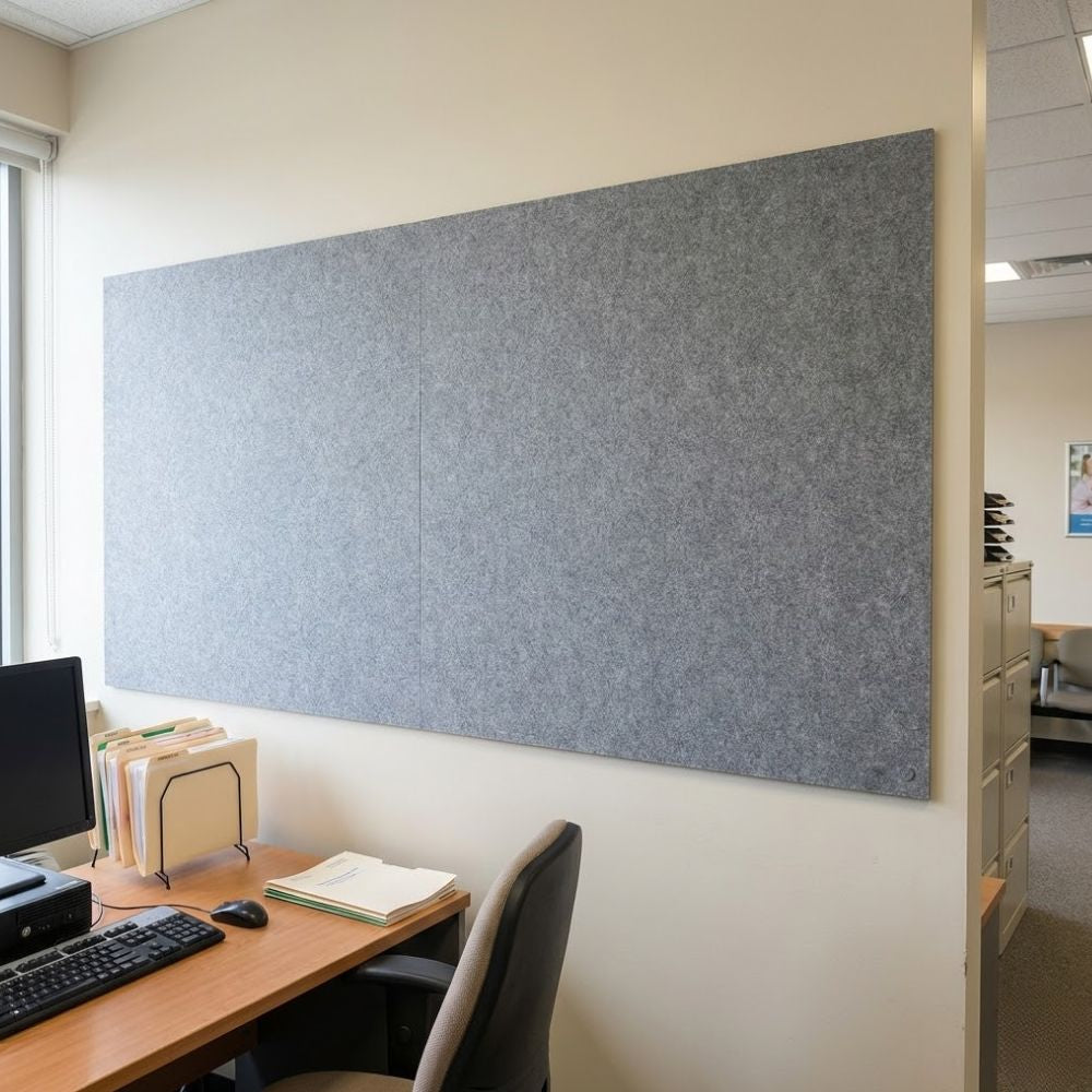 Grey unframed fire resistant felt noticeboard measuring 2400mm x 1200mm, extra wide wall mounted board installed in a modern office workspace with visible corner fixings.