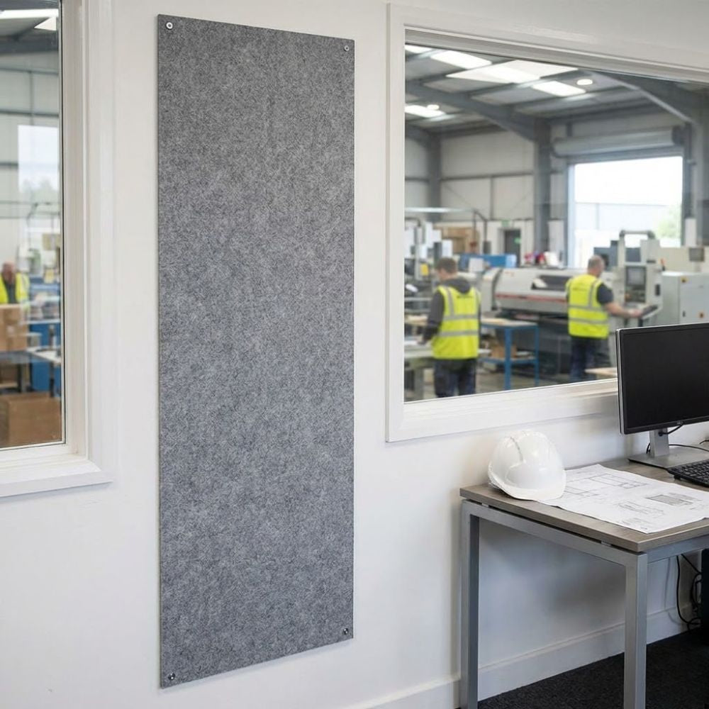 Grey unframed fire resistant felt noticeboard measuring 600mm x 1800mm, tall wall mounted panel installed in a warehouse office environment.
