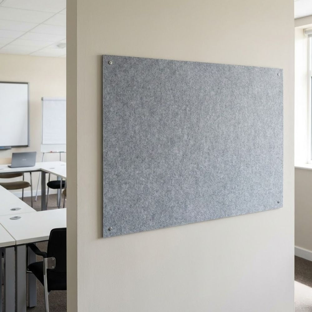 Grey unframed fire resistant felt noticeboard measuring 900mm x 600mm, wall mounted in a meeting room setting with discreet corner fixings.