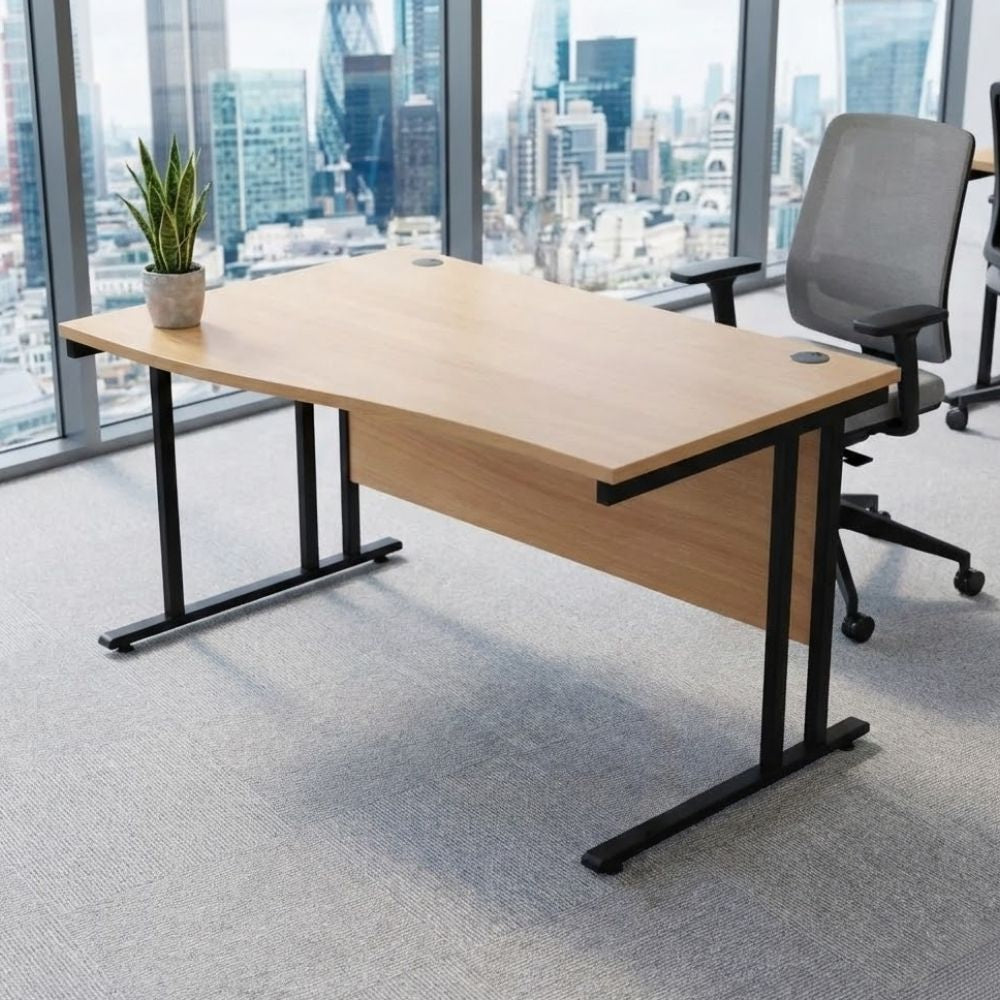 Left-hand wave office desk with a natural wood top and black frame, placed in a high-rise office with panoramic city views and ergonomic task chair.