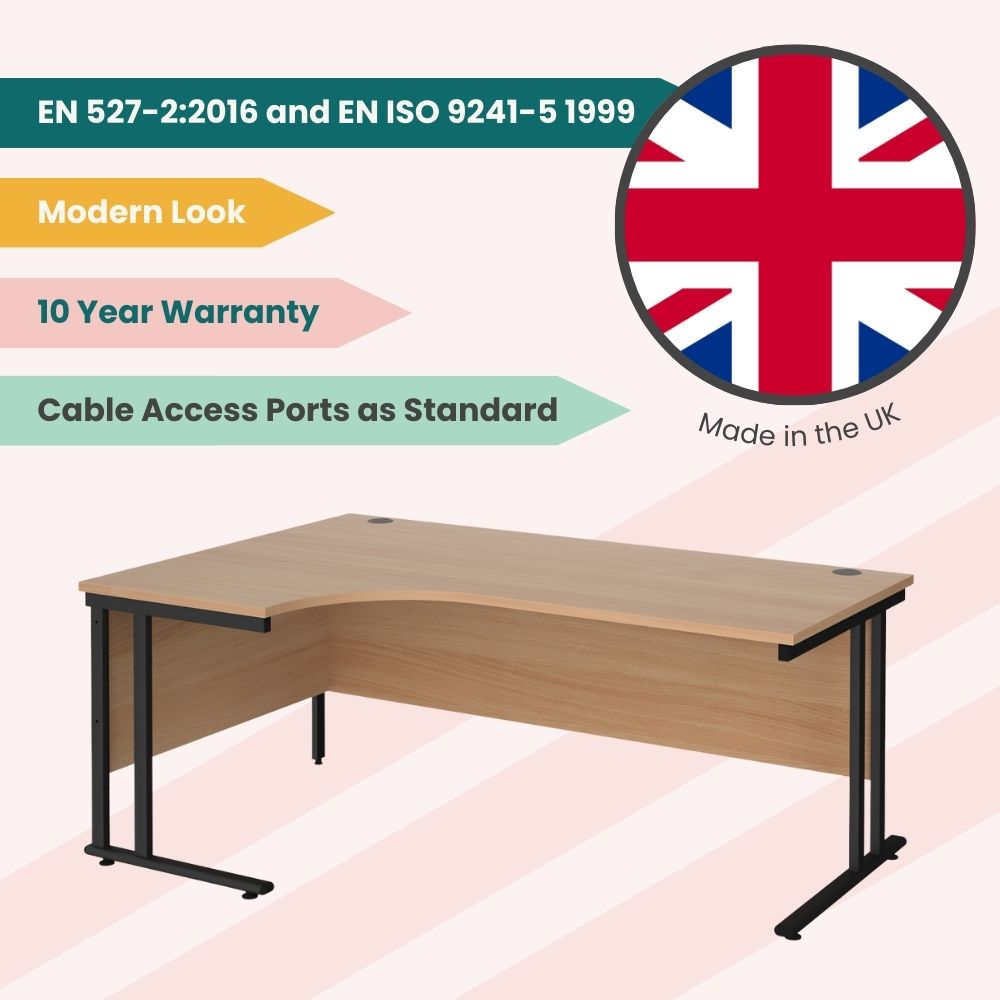 Left-hand wave desk made in the UK, featuring a wood-finish curved top, black cantilever legs, modesty panel, and standard cable access ports, with a 10-year warranty and modern design.