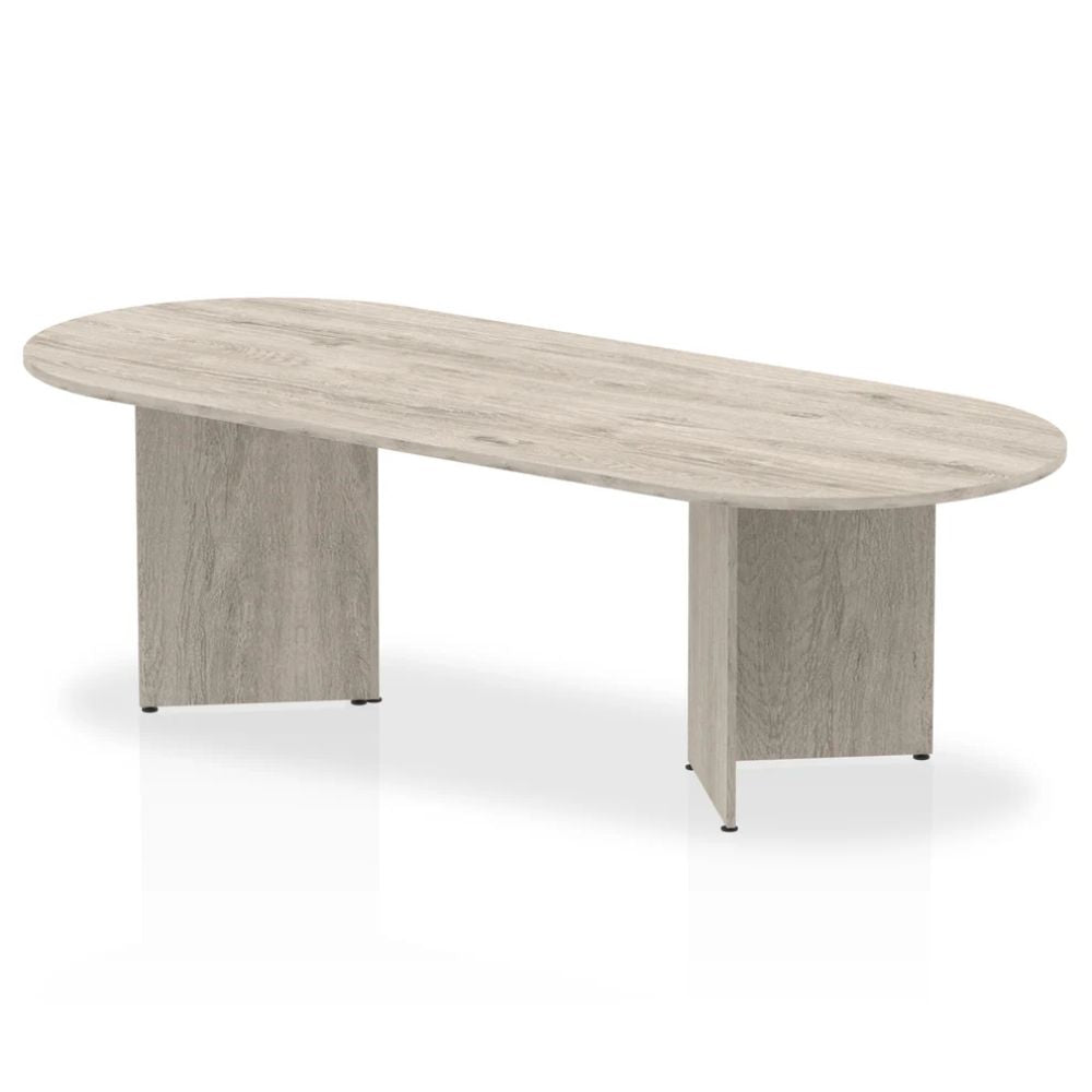 Contemporary light oak organic shaped conference table with two solid panel wood bases on a clean studio background.