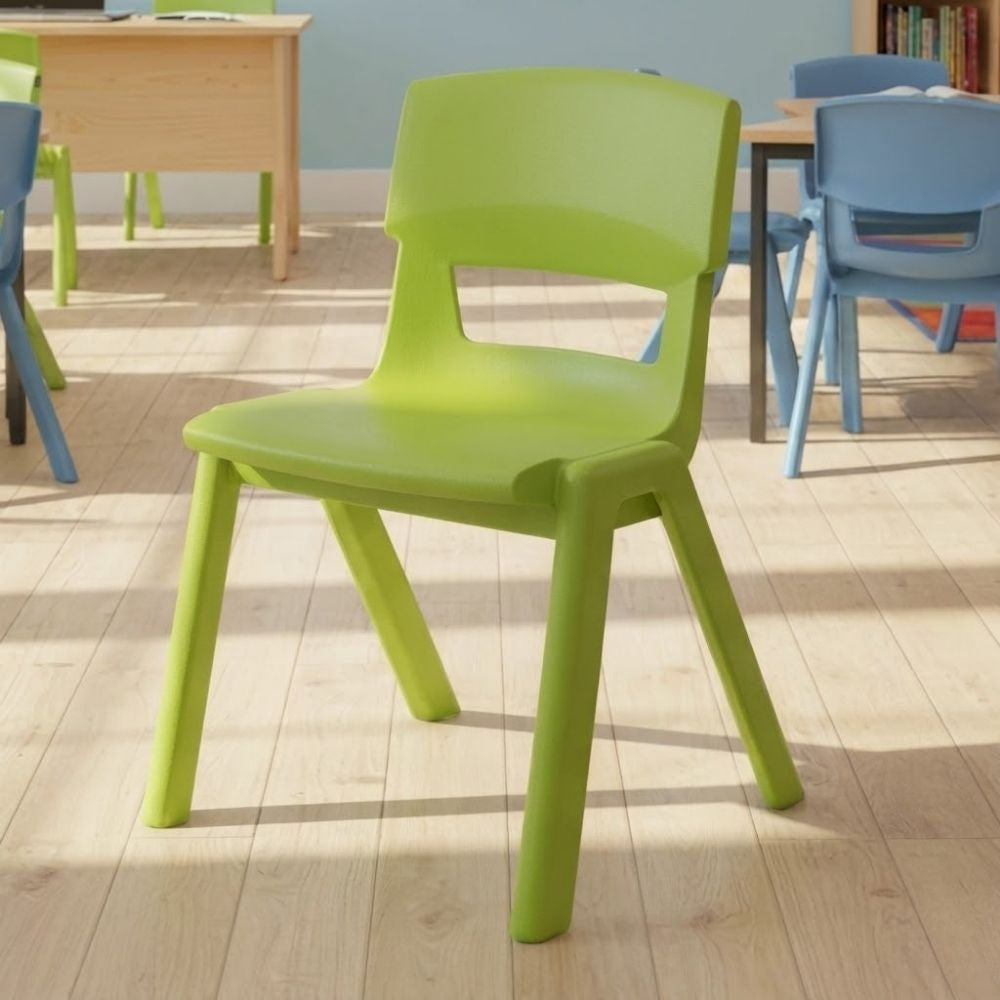 A lime green plastic classroom chair placed in a bright room with blue and green chairs, wooden desks and natural light highlighting the light wood flooring.