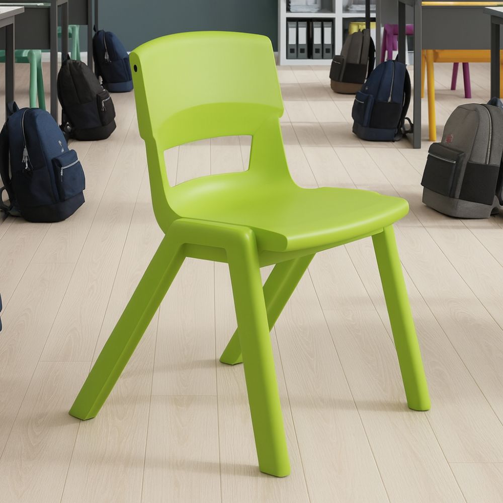 A lime green ergonomic school chair placed on pale wood flooring in a secondary classroom, surrounded by pupil desks and rucksacks.
