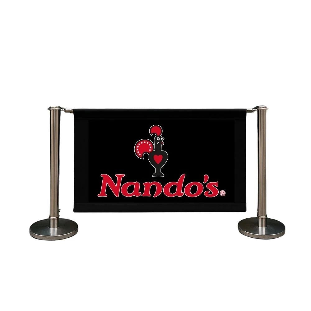 Black Nando’s banner with red rooster logo supported by metal stanchions, ideal for restaurant branding and queue management.