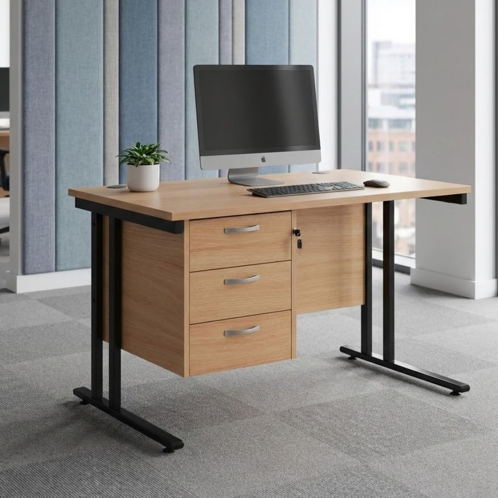 Office desk featuring a three-drawer pedestal, black cantilever frame, and wooden top, equipped with a desktop computer and potted plant, positioned in a stylish workspace.