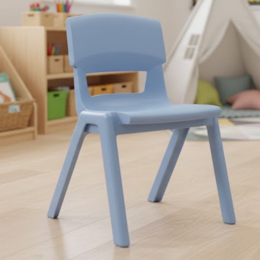 A light pastel blue school chair positioned in a play-based reception classroom with open shelving and cosy reading corners.