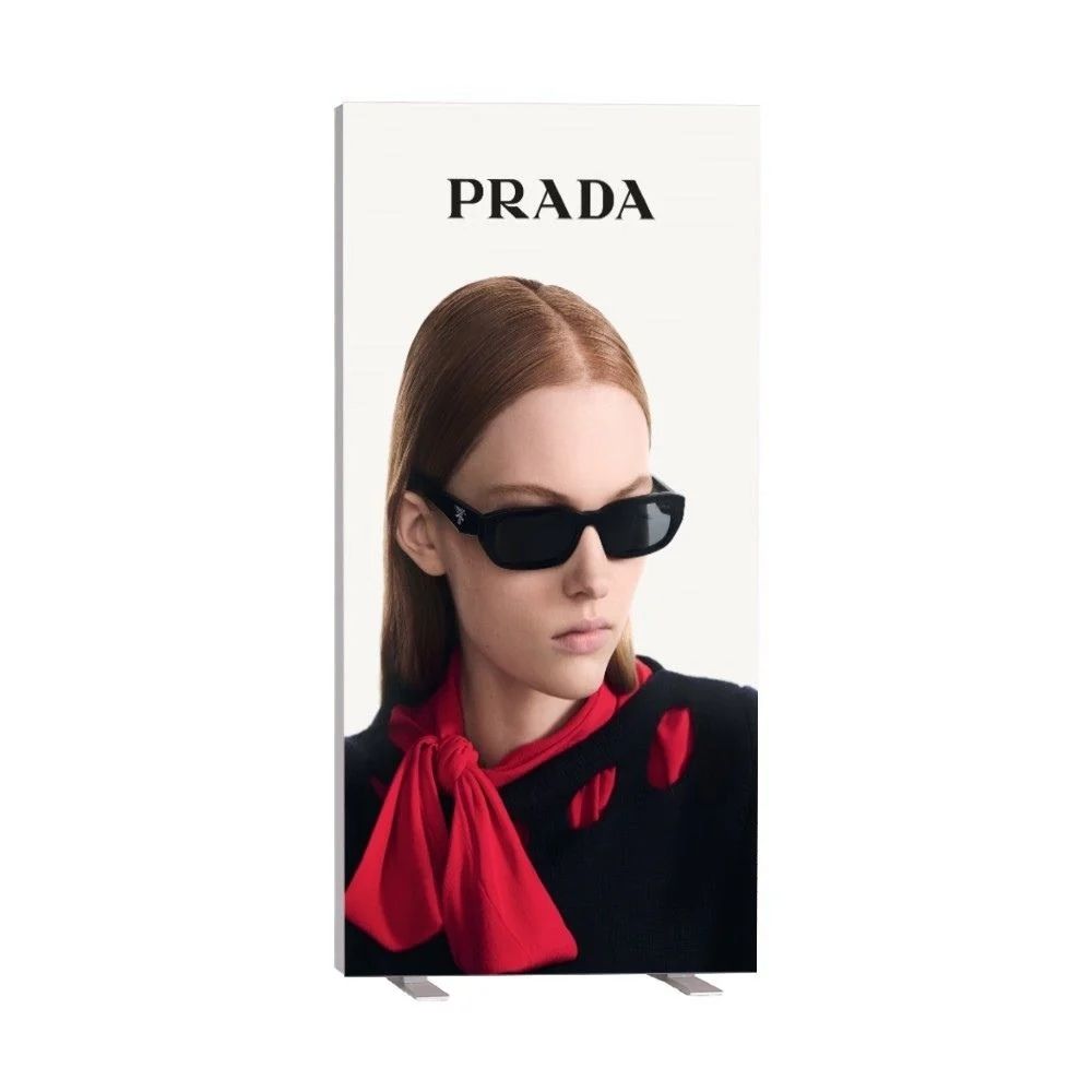 PRADA banner with bold logo and model styling, designed for luxury fashion promotions in retail spaces.