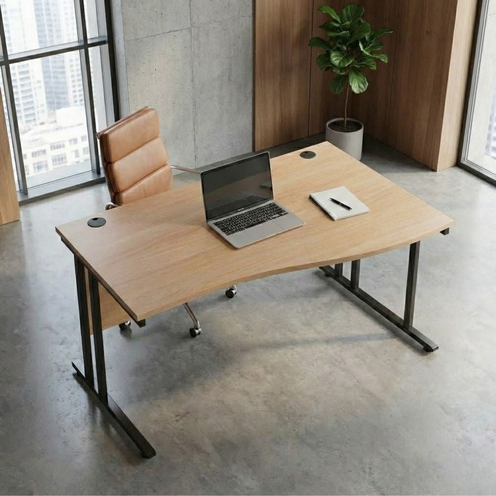 Right-hand wave office desk with a wood-finish curved top and black metal frame, styled with a laptop and notepad, set in a high-rise corner office with concrete flooring.
