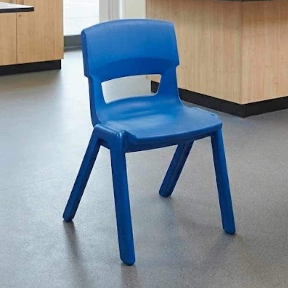 A royal blue ergonomic lab chair placed in a secondary school science classroom, surrounded by wooden cabinetry and clean, durable flooring.