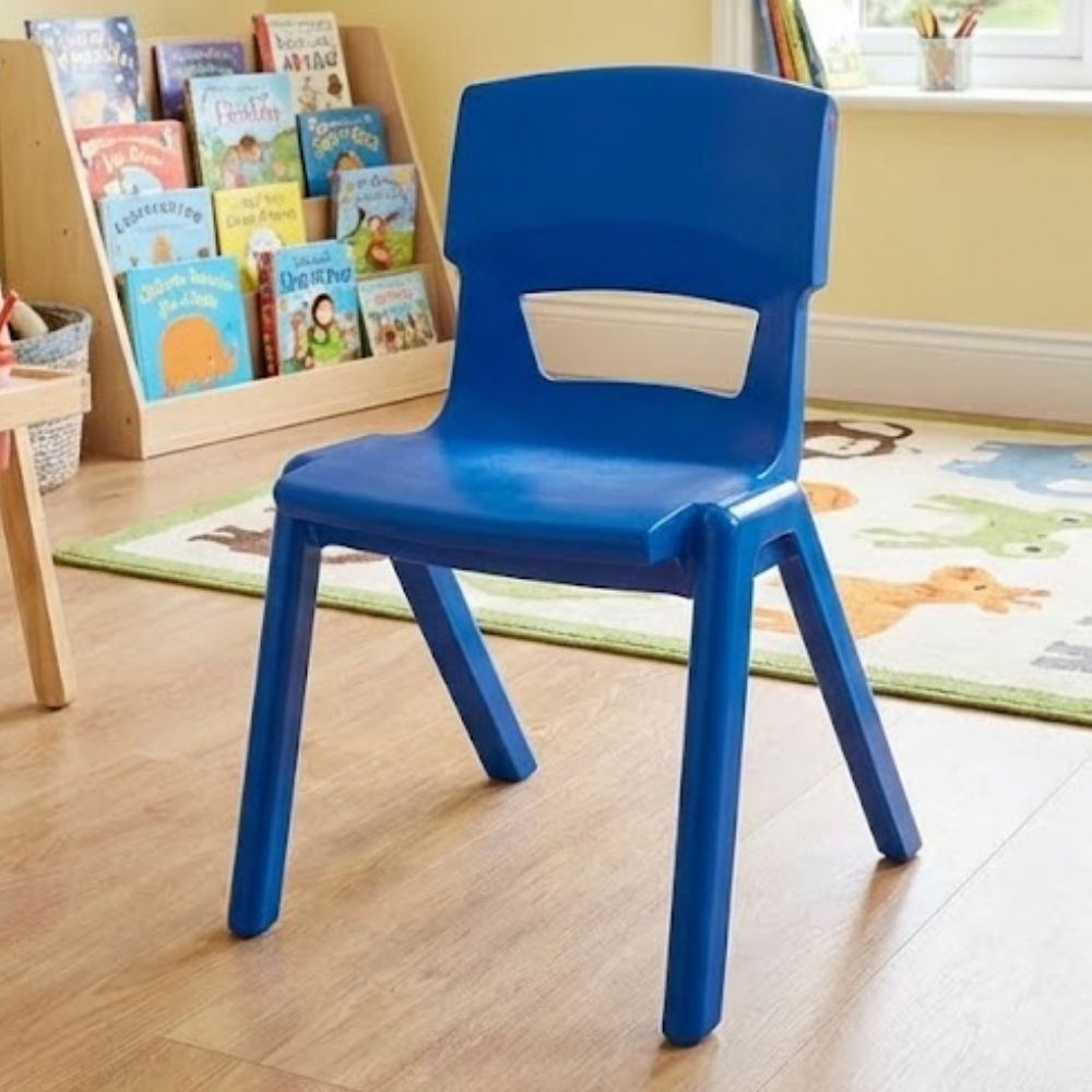 A vibrant royal blue nursery chair positioned on wooden flooring near a low book stand filled with colourful storybooks, perfect for early reading areas.
