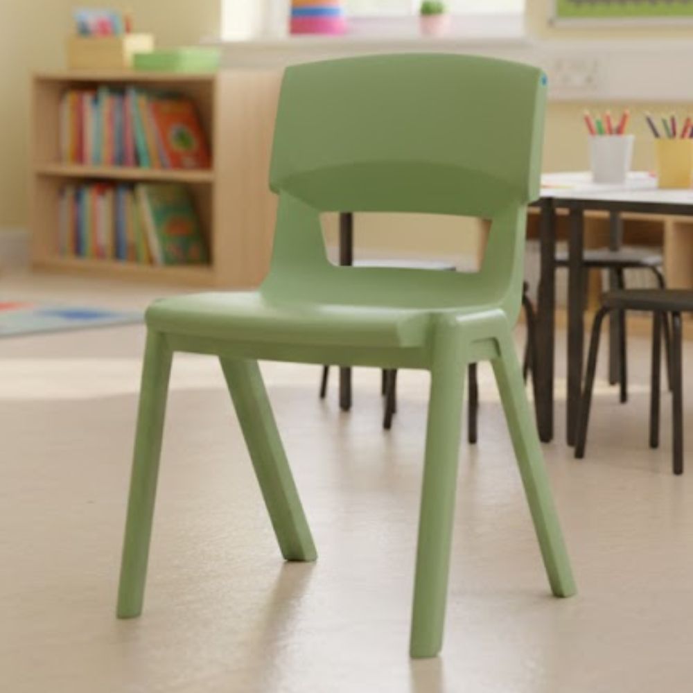 A sage green nursery chair positioned on smooth flooring near tables, bookshelves and bright displays, perfect for preschool creative play sessions.