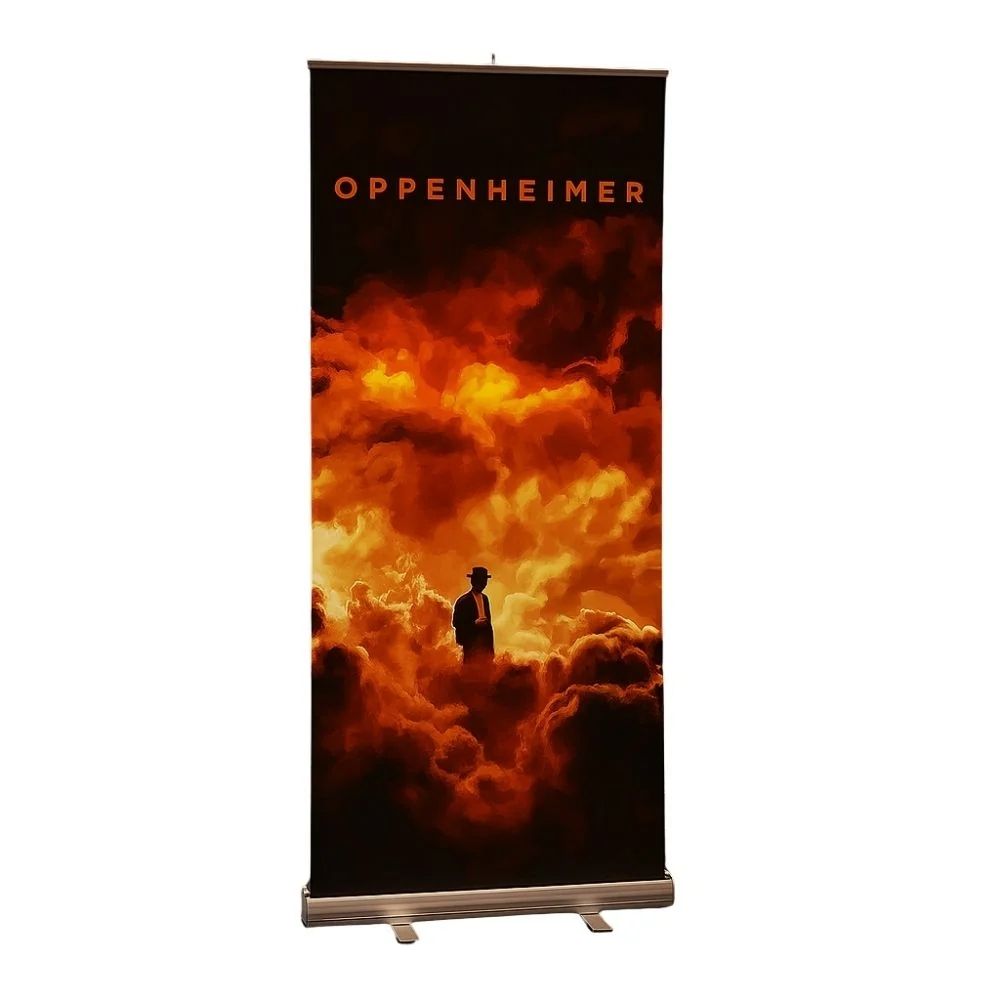 Oppenheimer promo banner with dramatic cloudscape and silhouetted figure, built for cinematic displays.