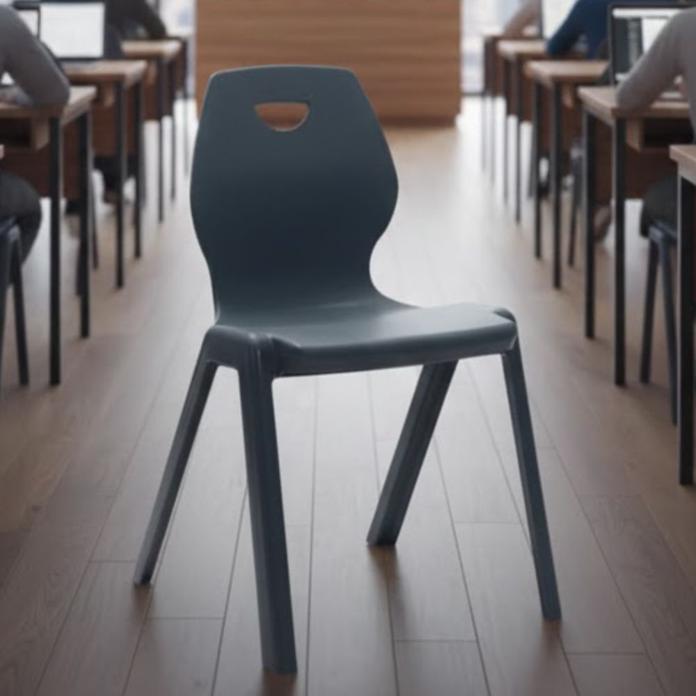 Single dark grey plastic chair with curved backrest and top handle, placed centrally in a classroom aisle.
