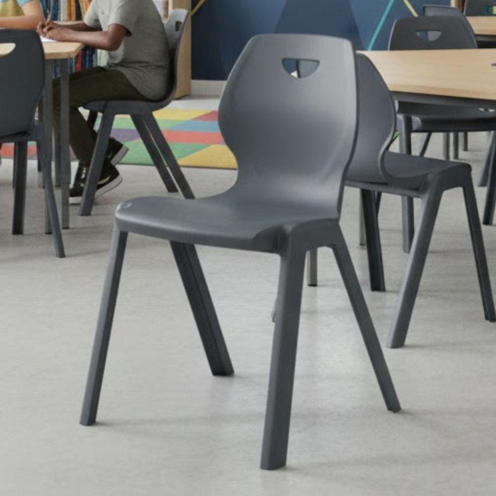 Dark grey plastic chairs with triangular backrest cutouts and ergonomic design for stacking and classroom use.