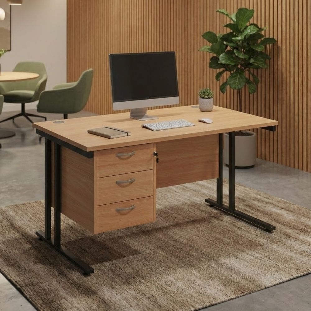 Modern office desk with a three-drawer pedestal, desktop computer, and accessories, placed in a warm interior with wooden wall panelling and cosy furnishings.