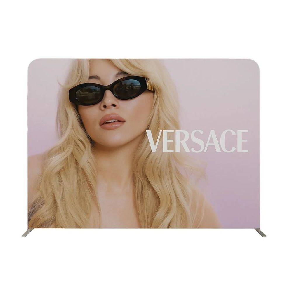 Versace display with blonde model and soft gradient backdrop, designed for high-end fashion promotion.