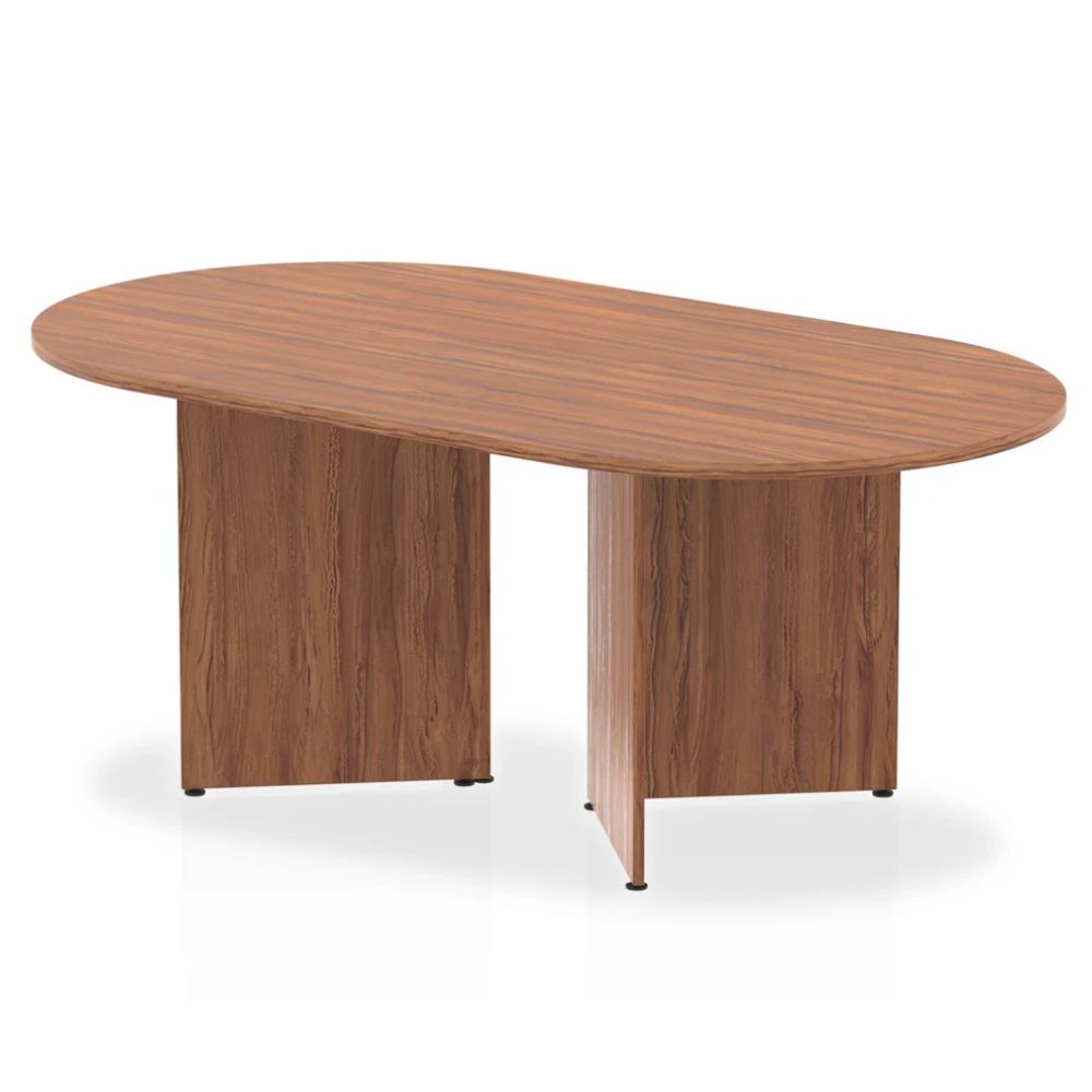 Modern walnut organic shaped conference table with solid panel wood bases in a minimalist studio environment.