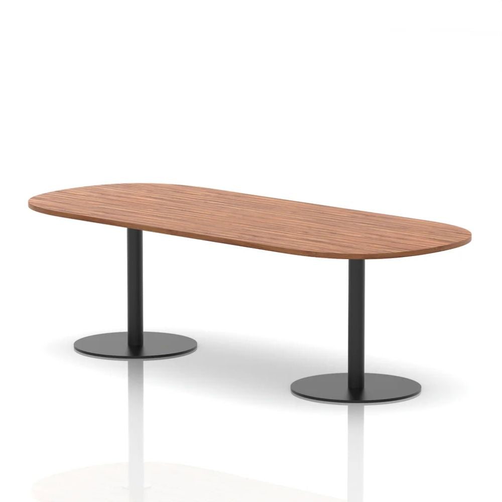 Contemporary walnut organic shaped meeting table with dual black round pedestal legs on a clean studio background.