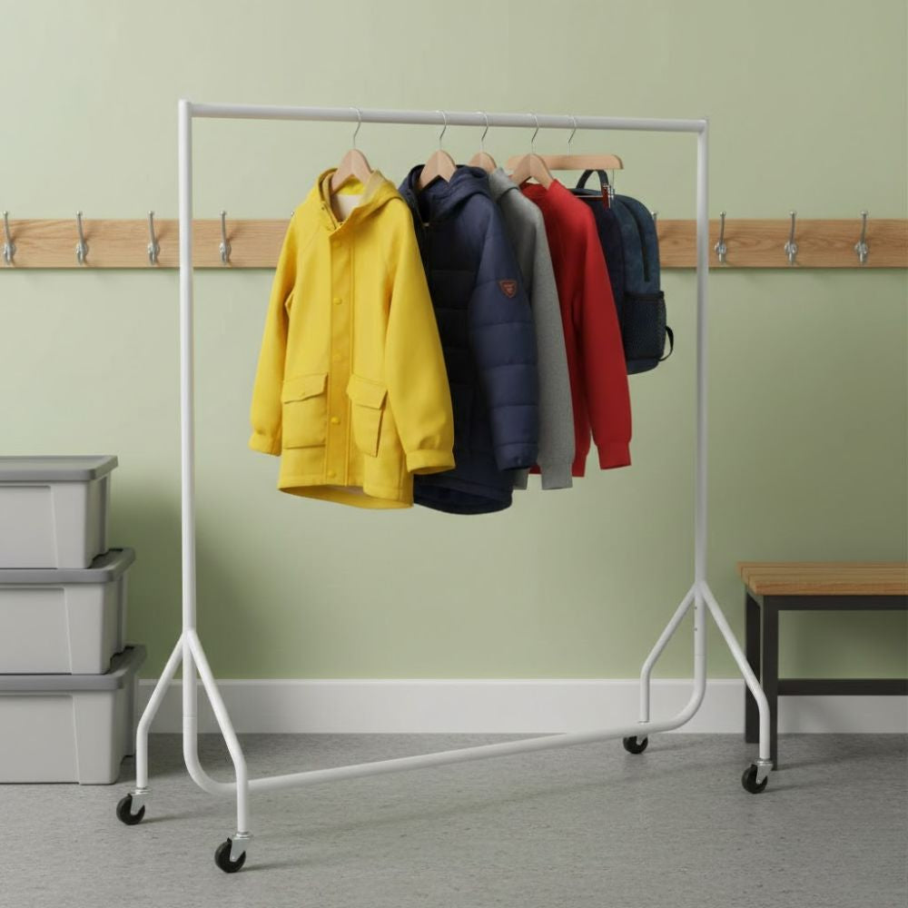 White 5ft mobile clothes rail displaying children’s coats and jackets on wooden hangers in a school cloakroom, with wall hooks and storage boxes in the background.
