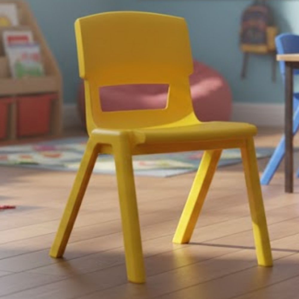 A yellow plastic nursery chair in a cosy classroom with wooden flooring, a beanbag and educational wall decorations.