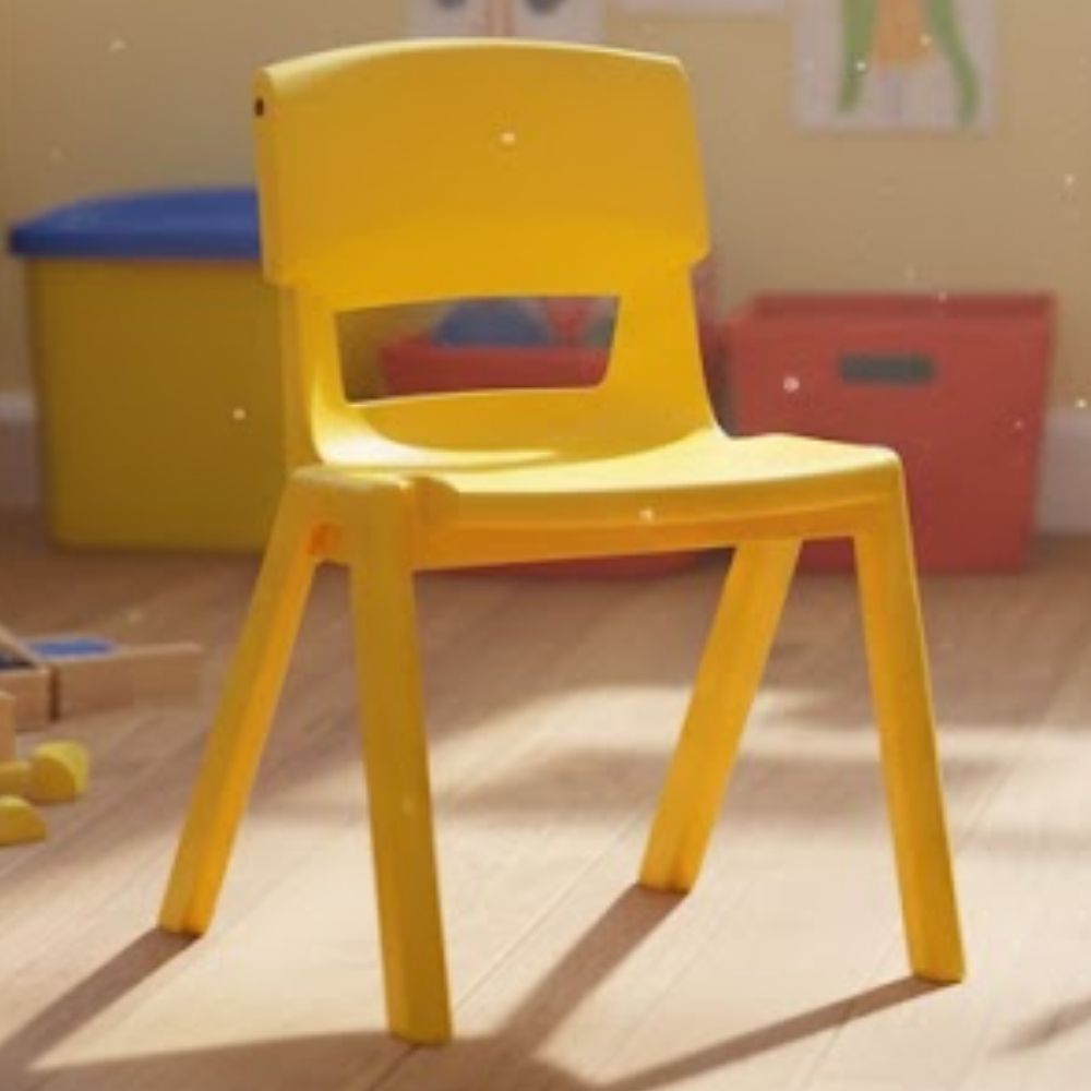 A yellow plastic chair in an early years setting filled with toys, sunbeams and a wooden floor, creating a bright and engaging learning area.